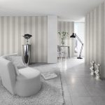Living room interior in pastel shades with gray striped wallpaper