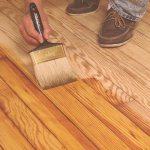 Apply varnish to the floor with a brush